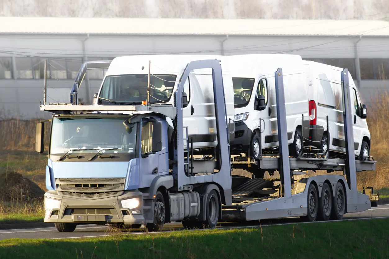 Car transporter truck transporting vehicles on highway - Alabama auto transport