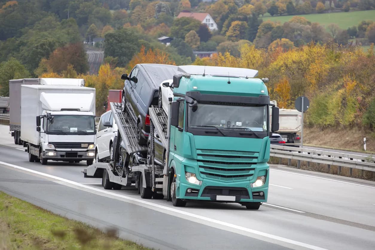 Car transporter truck transporting vehicles on highway - Delaware auto transport