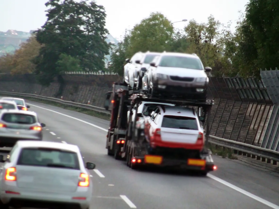 Car transporter truck transporting vehicles on highway - Kentucky auto transport