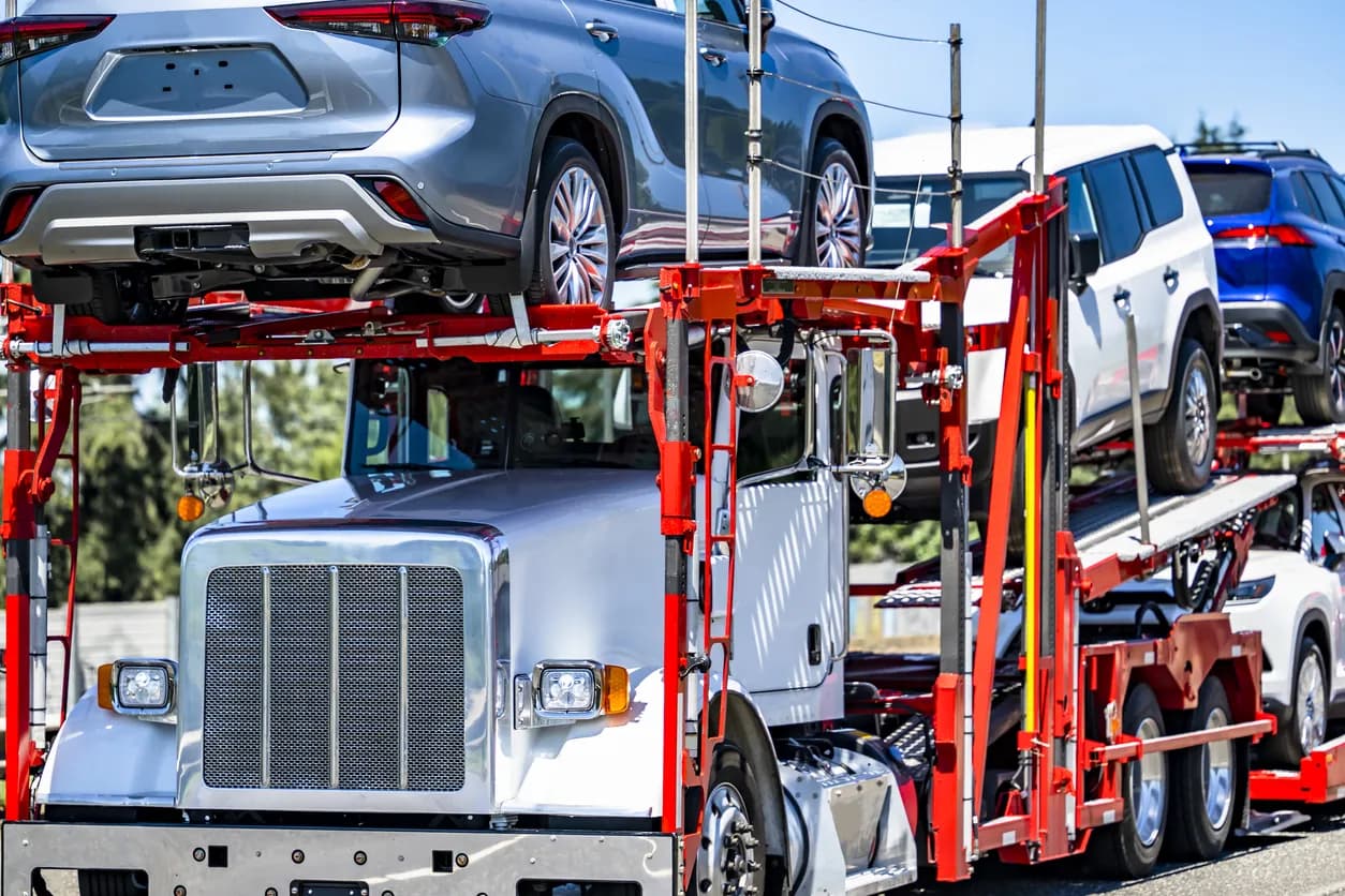 Car transporter truck transporting vehicles on highway - New York auto transport
