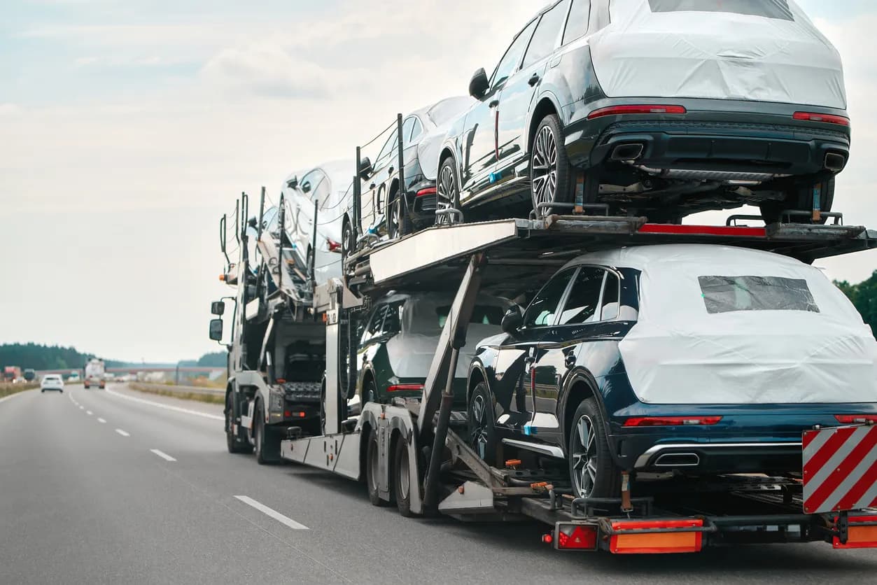 Car transporter truck transporting vehicles on highway - Ohio auto transport