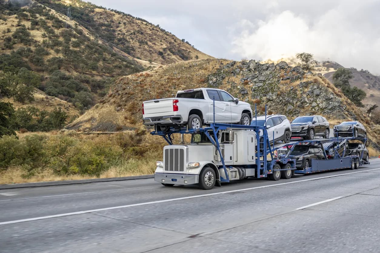 Car transporter truck transporting vehicles on highway - Pennsylvania auto transport