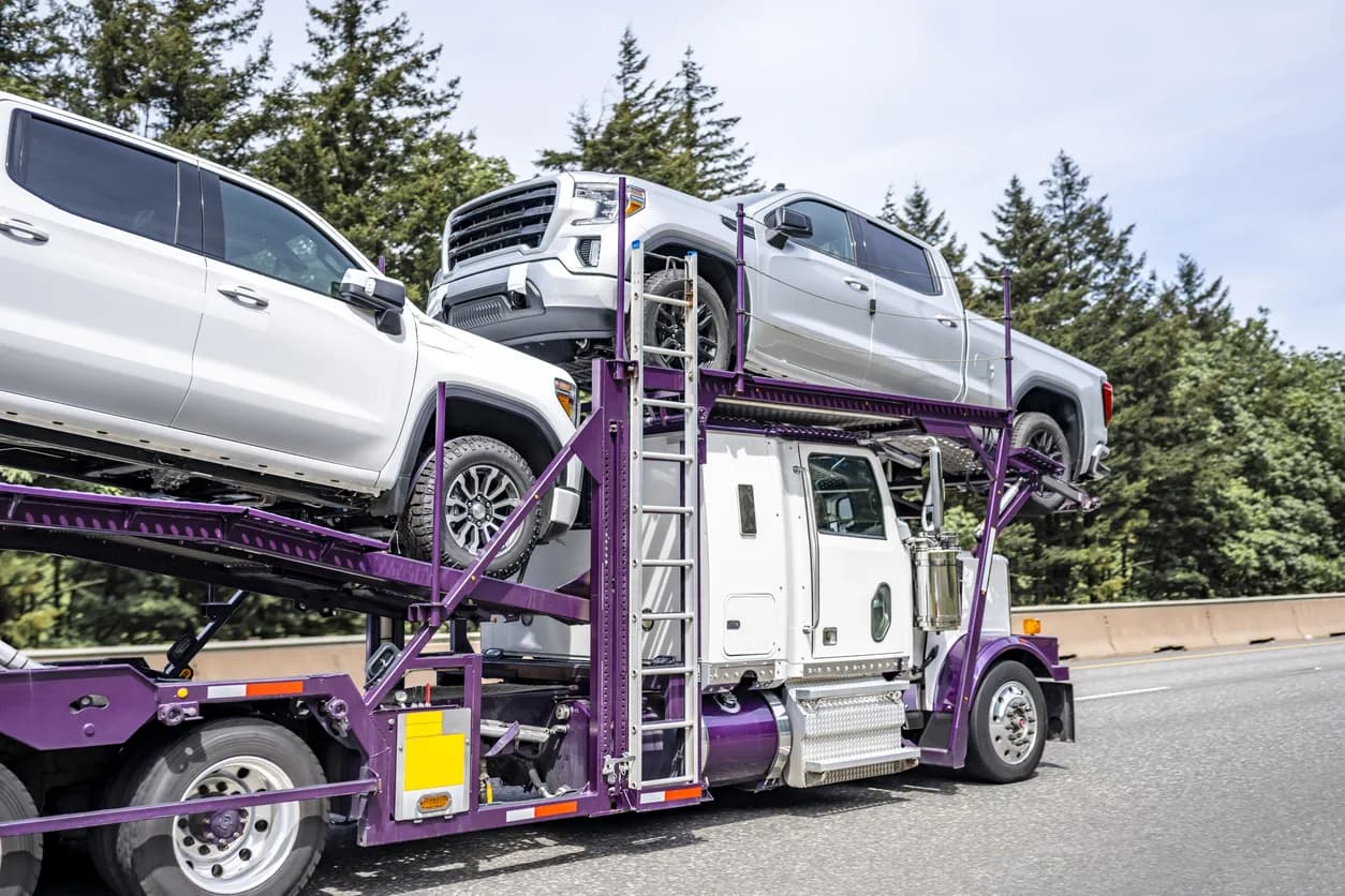 Car transporter truck transporting vehicles on highway - Texas auto transport