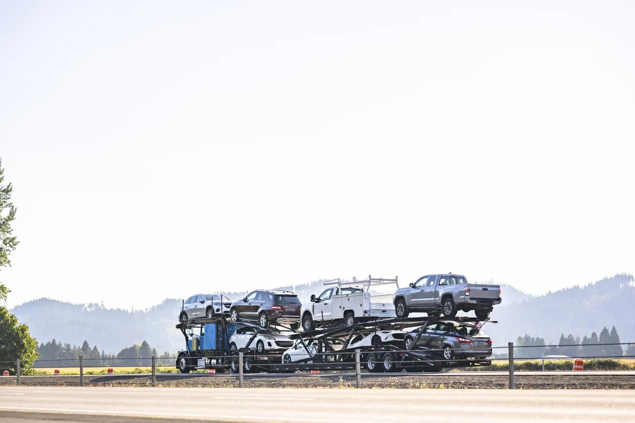 Car transporter truck transporting vehicles on highway - Arizona auto transport