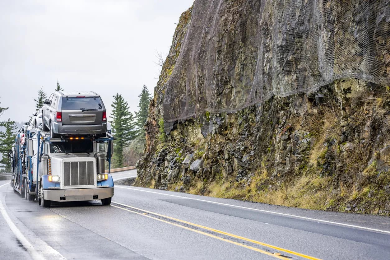 Car transporter truck transporting vehicles on highway - Colorado auto transport