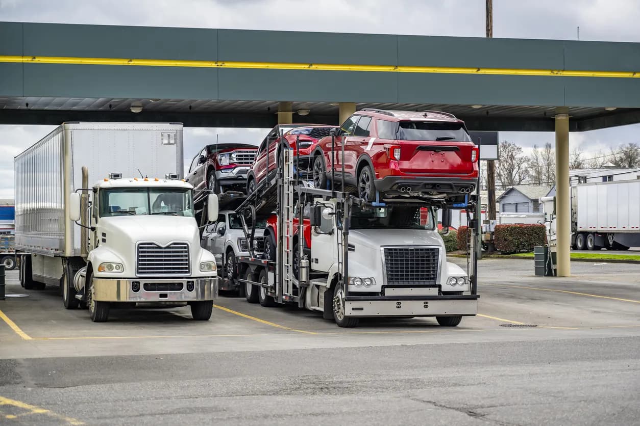 Car transporter truck transporting vehicles on highway - Florida auto transport