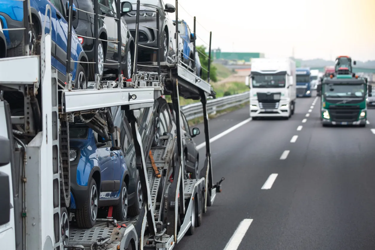 Car transporter truck transporting vehicles on highway - Idaho auto transport