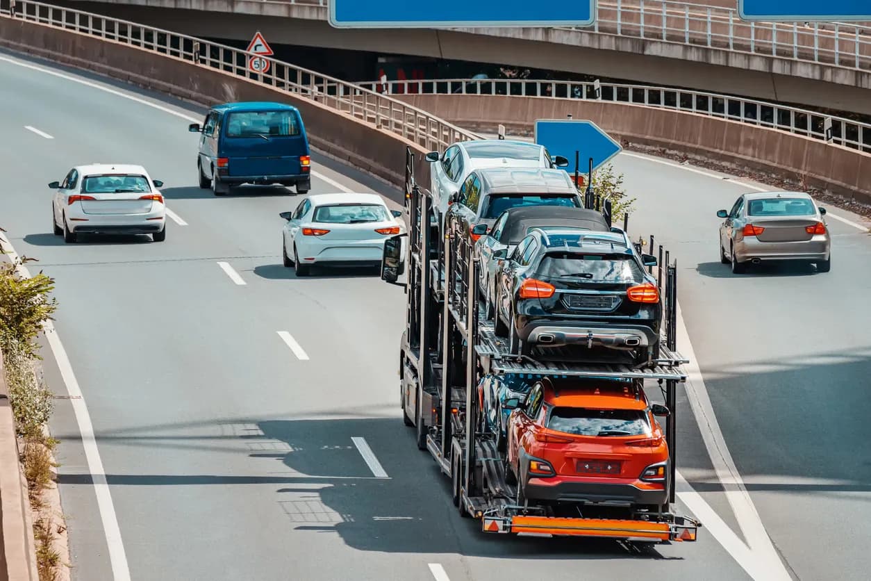Car transporter truck transporting vehicles on highway - Kansas auto transport