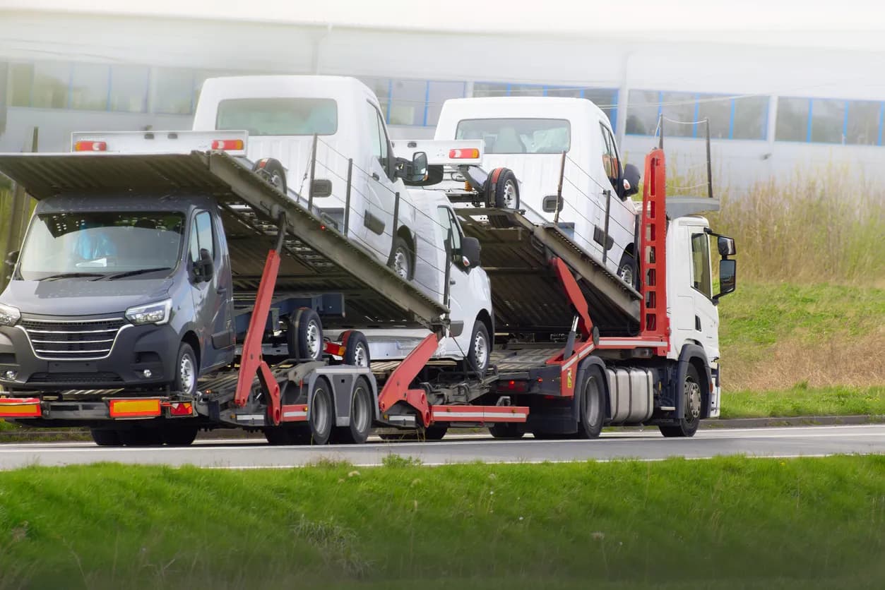 Car transporter truck transporting vehicles on highway - Maryland auto transport
