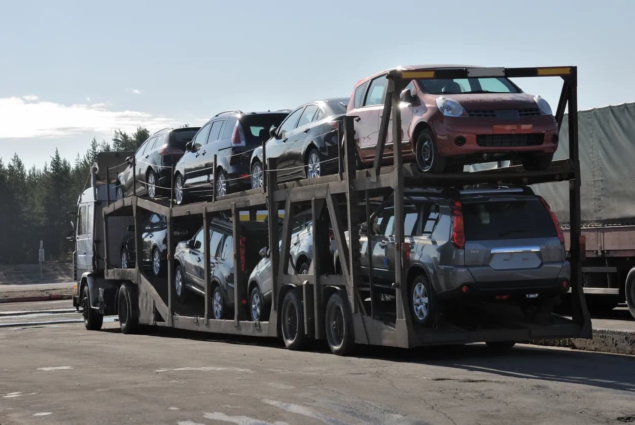 Car transporter truck transporting vehicles on highway - Michigan auto transport